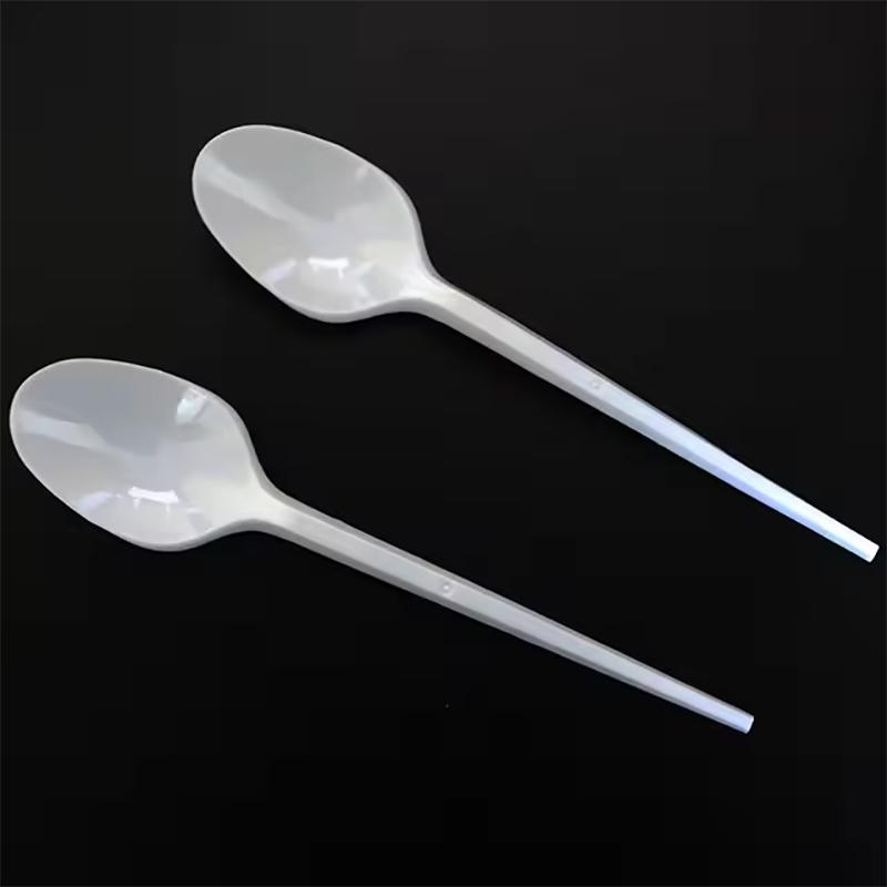 Disposable white plastic spoon